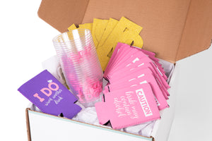 Slaydies Night white box with purple and pink coozies with clear plastic cups and gold letter banner bachelorette party items